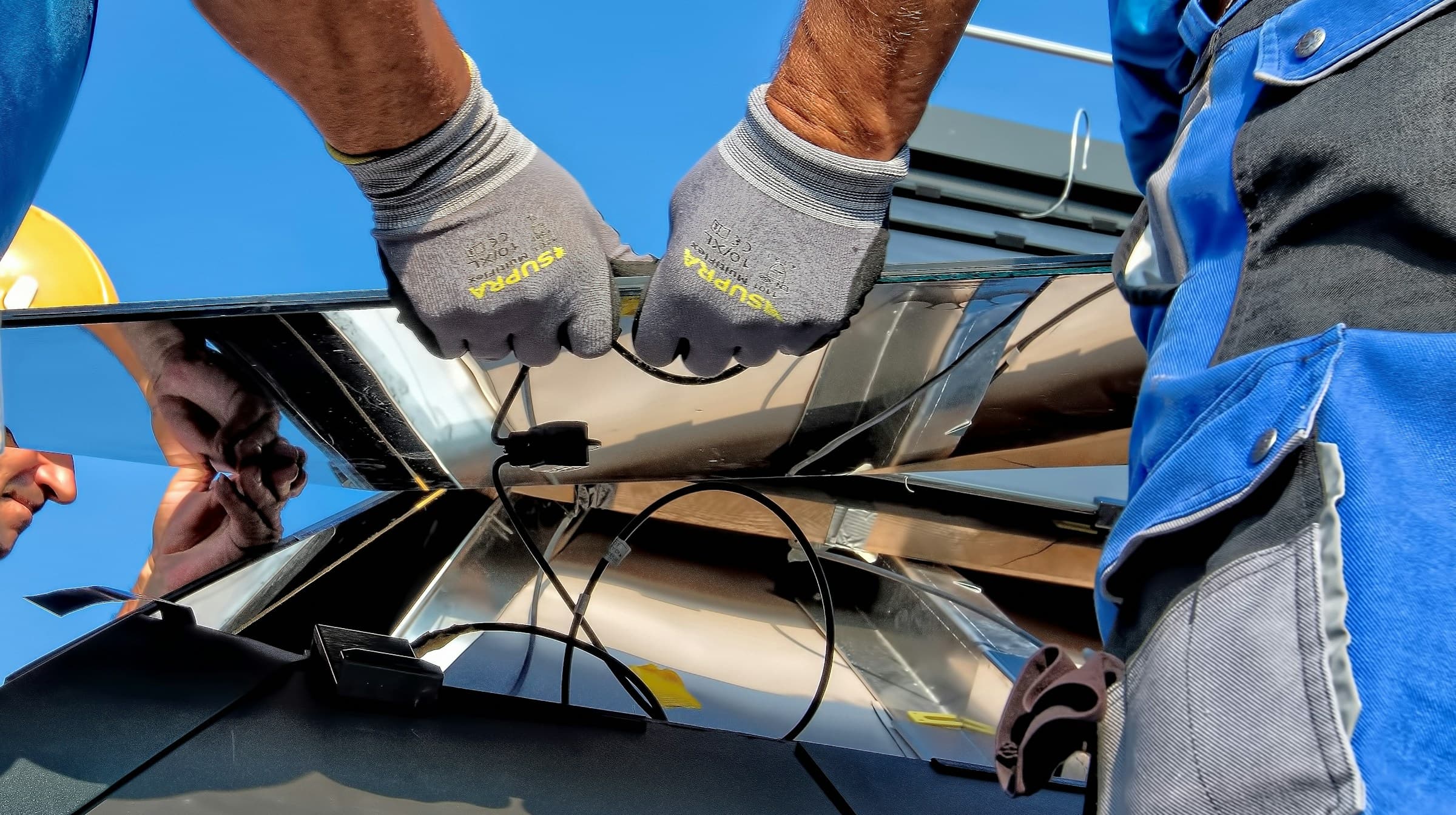 Solar panels being installed under a clear sky
